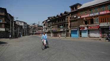 A Kashmiri man rides a bicycle past a closed market during a strike in Srinagar, Indian controlled Kashmir, Thursday, Aug. 30, 2018. (AP)