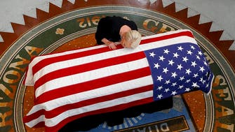 IN PICTURES: John McCain’s family cries over flag-draped casket