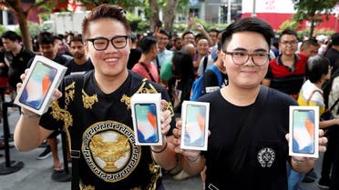 First customers to buy iPhone X Kittiwat Wang, 22, and Mod, 22, of Bangkok pose with their iPhone X at the Apple store in Singapore November 3, 2017. (Reuters)