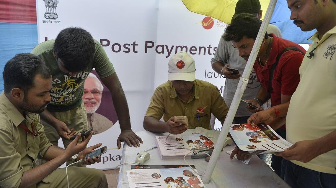 Indian post office employees help customers for opening new post office bank account ‘India Post Payment Bank’ in Siliguri on September 1, 2018. (AFP)