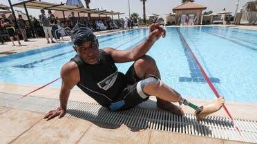 An Iraqi civilian who lost a limb during the government offensive against ISIS in the northern city of Mosul sits by a pool in Erbil. (AFP)