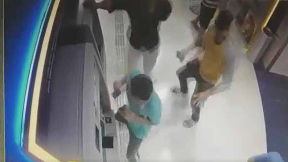CCTV footage showed at least five men inside the booth running to safety as the car crashed through the window into the bank. (Screenshot)