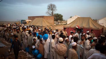 Displaced men line up as they wait for food during a food distribution at the Chota Lahore refugee camp, at Swabi, in northwest Pakistan, Wednesday, May 20, 2009. (AP)