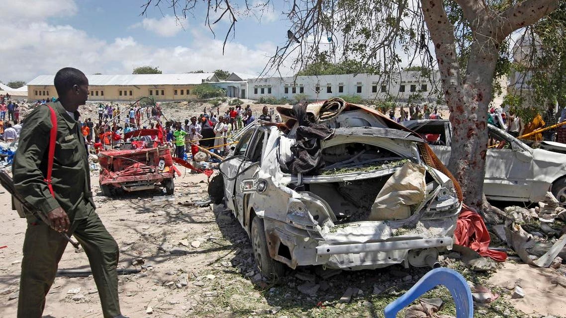A Somali soldier walks near the wreckage of vehicles at the scene of a blast outside the compound of a district headquarters in the capital Mogadishu, Somalia Sunday, Sept. 2, 2018. (AP)