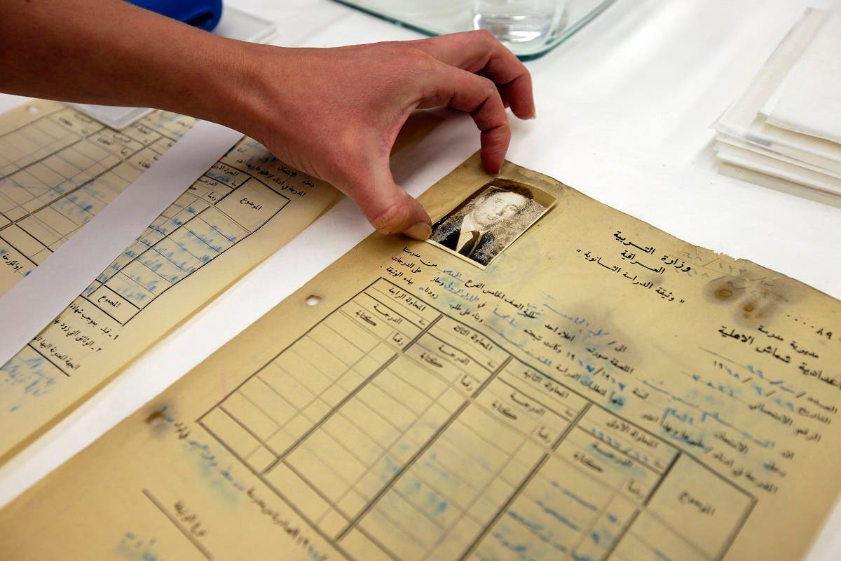 This photo taken Sept. 30, 2013 shows Anna Friedman, a conservator, putting a photograph in place as she works on Iraqi Jewish documents at the National Archives in College Park, Md. (AFP)