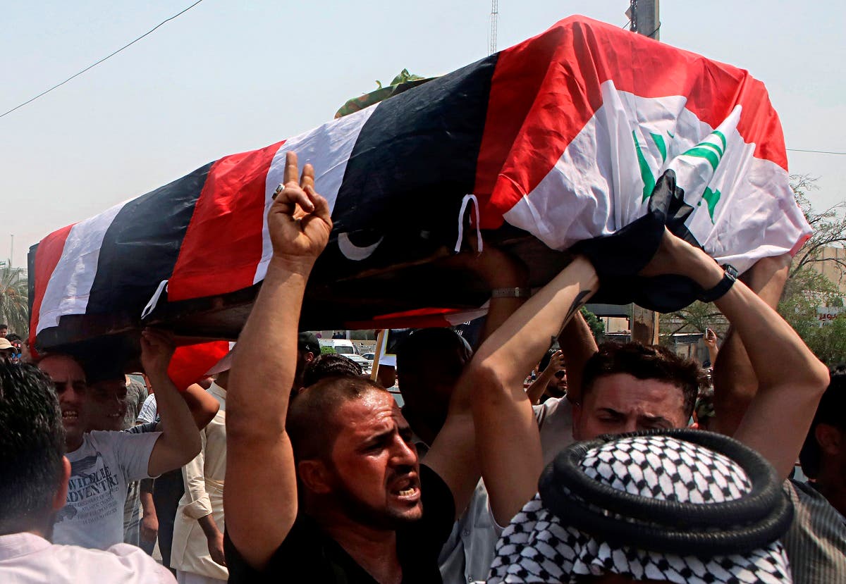 Mourners carry the Iraqi flag-draped coffin of Mekki Yasser, Basra, Iraq. (AP)