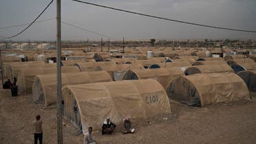 Displaced people sit outside their tents in the Hamam Alil camp, south of Mosul, Iraq, Tuesday, Nov. 7, 2017. (AP)