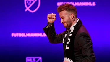David Beckham, wearing a league scarf, salutes a section of the crowd at this official announcement for Miami's MLS expansion team in Miami, Florida. (Reuters)