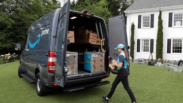 Parisa Sadrzadeh, a senior manager of logistics for Amazon.com, demonstrates a package delivery for journalists at a media event in Seattle. (AP)