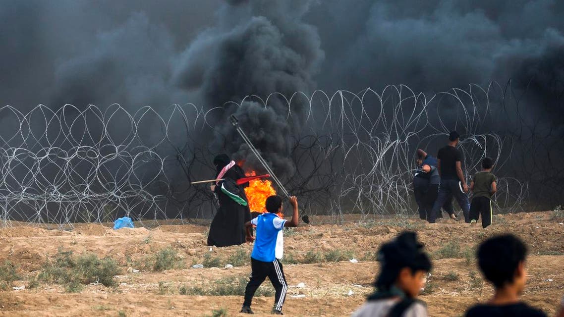 A young Palestinian protester uses a slingshot to hurl stones at Israeli forces during clashes following a demonstration at the Israel-Gaza border, east of Gaza City in the central Gaza Strip on September 7, 2018. (AFP)