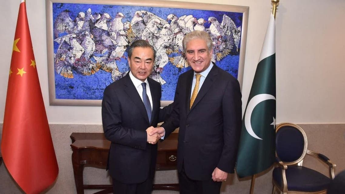 Pakistan’s Foreign Minister Shah Mehmood Qureshi shakes hand with State Councillor and Foreign Minister Wang Yi at the Ministry of Foreign Affairs in Islamabad, in Pakistan, on September 8, 2018. (AFP)