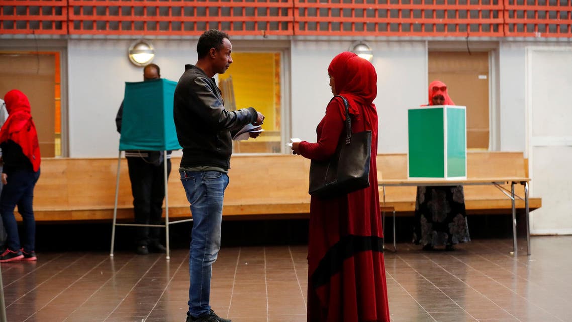 People arrive at a polling station during a general election, in the Rinkeby neighbourhood in Stockholm. (AP)