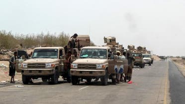 Yemeni fighters from the Amalqa (Giants) Brigades gather on the side of a road in Hodeidah. (AFP)