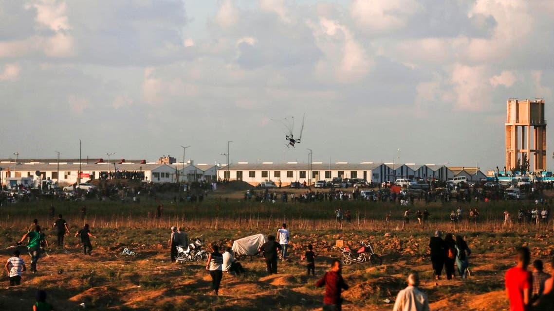 An Israeli army drone falls after being covered by a net thrown at it by Palestinian protestors during clashes following a demonstration along the Israel-Gaza border. (AFP)