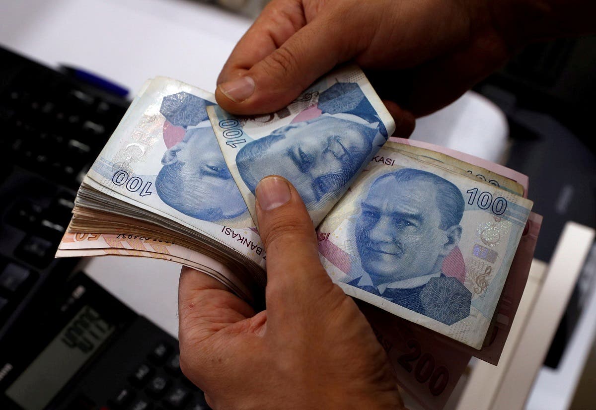 A money changer counts Turkish lira banknotes at a currency exchange office in Istanbul. (Reuters)