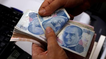 A money changer counts Turkish lira banknotes at a currency exchange office in Istanbul. (Reuters)