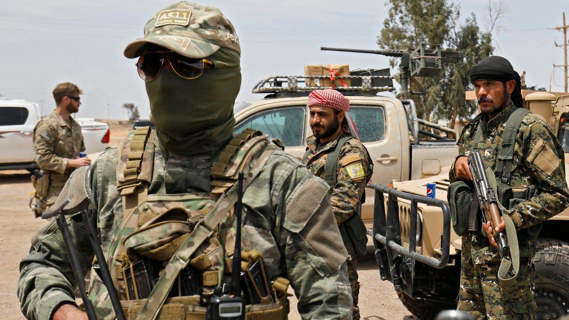 Members of the Syrian Democratic Forces (SDF) gather at the al-Tanak oil field as they prepare to relaunch a military campaign against the Islamic State (IS) group, near Abu Kamal, province of Deir Ezzor, eastern Syria on May 1, 2018.