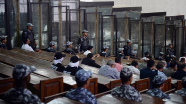 This picture shows the courtroom and soundproof glass dock (bottom) during the trial of 700 defendants including Egyptian photojournalist Mahmoud Abu Zeid, widely known as Shawkan, in the capital Cairo, on September 8, 2018. An Egyptian court on September 8 handed a five-year jail sentence to prominent photojournalist Zeid, known as Shawkan, who earlier this year received UNESCO's World Freedom Prize. Shawkan was one of more than 700 defendants on trial in the same case, most of them facing charges of killing police and vandalising property during the clashes. The same court that jailed him also confirmed on Saturday death sentences initially issued in July against 75 defendants, including leaders of Morsi's outlawed Muslim Brotherhood.