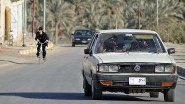 An Iraqi man drives his car on January 24, 2012 through the Askari neighbourhood of Haditha, a town of around 80,000 people in the western Iraq Anbar province, where 24 Iraqis were killed by US troops in 2005. Haditha residents and relatives of those killed by US troops in 2005 have voiced shock and disgust over the light sentence meted out to a US soldier involved in the massacre. AFP PHOTO/ AZHAR SHALLAL