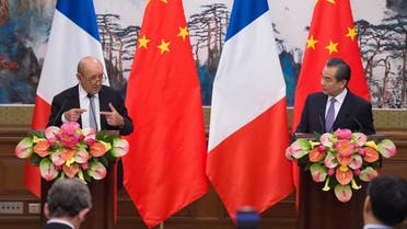 French Foreign Affairs Minister Jean-Yves Le Drian (L) and China’s Foreign Minister Wang Yi (R) attend a joint a press conference at the Diaoyutai State Guesthouse in Beijing on September 13, 2018. (AFP)