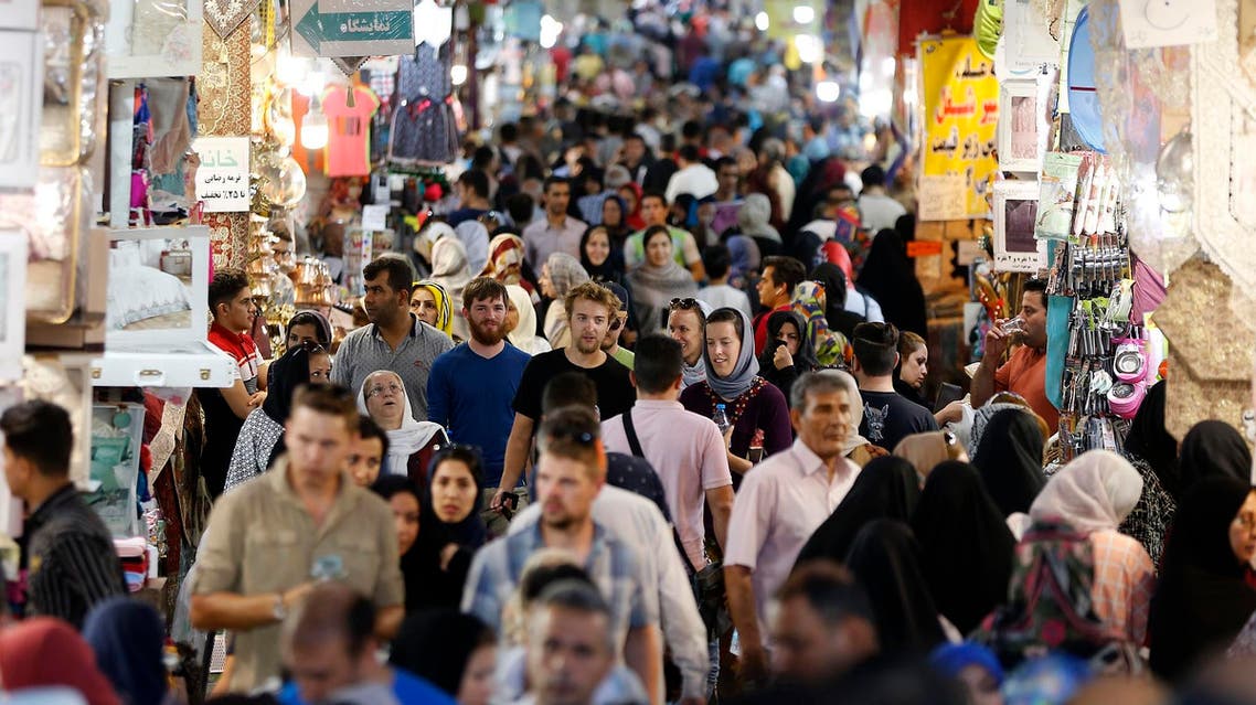People walk through Tehran’s ancient Grand Bazaar in Tehran on July 28, 2018. (AFP)
