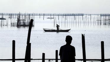A worker recovers net in a fish pen before Super Typhoon Mangkhut hits the main island of Luzon, in Muntinlupa, Metro Manila, in Philippines, on September 13, 2018. (Reuters)