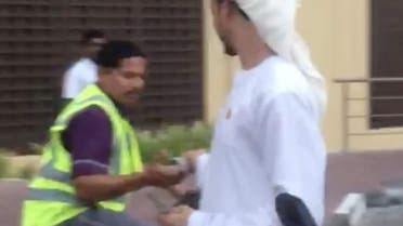 Video grab of a man in traditional Arab dress seen “distributing cash among strangers” in Dubai.