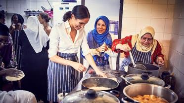 Britain's Meghan, Duchess of Sussex, cooks with women in the Hubb Community Kitchen at the Al Manaar Muslim Cultural Heritage Centre in west London. (Jenny Zarins via Reuters))