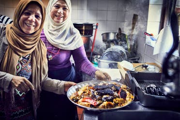 Intlak Al Saiegh and Ahlam Saeid cook in the Hubb Community Kitchen at the Al Manaar Muslim Cultural Heritage Centre. (Jenny Zarins/Handout via Reuters)