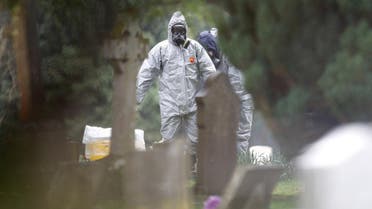 Members of the emergency services help each other to remove their protective suits at the site of the grave of Luidmila Skripal, wife of former Russian inteligence officer Sergei Skripal, at London Road Cemetery in Salisbury. (File photo: Reuters)