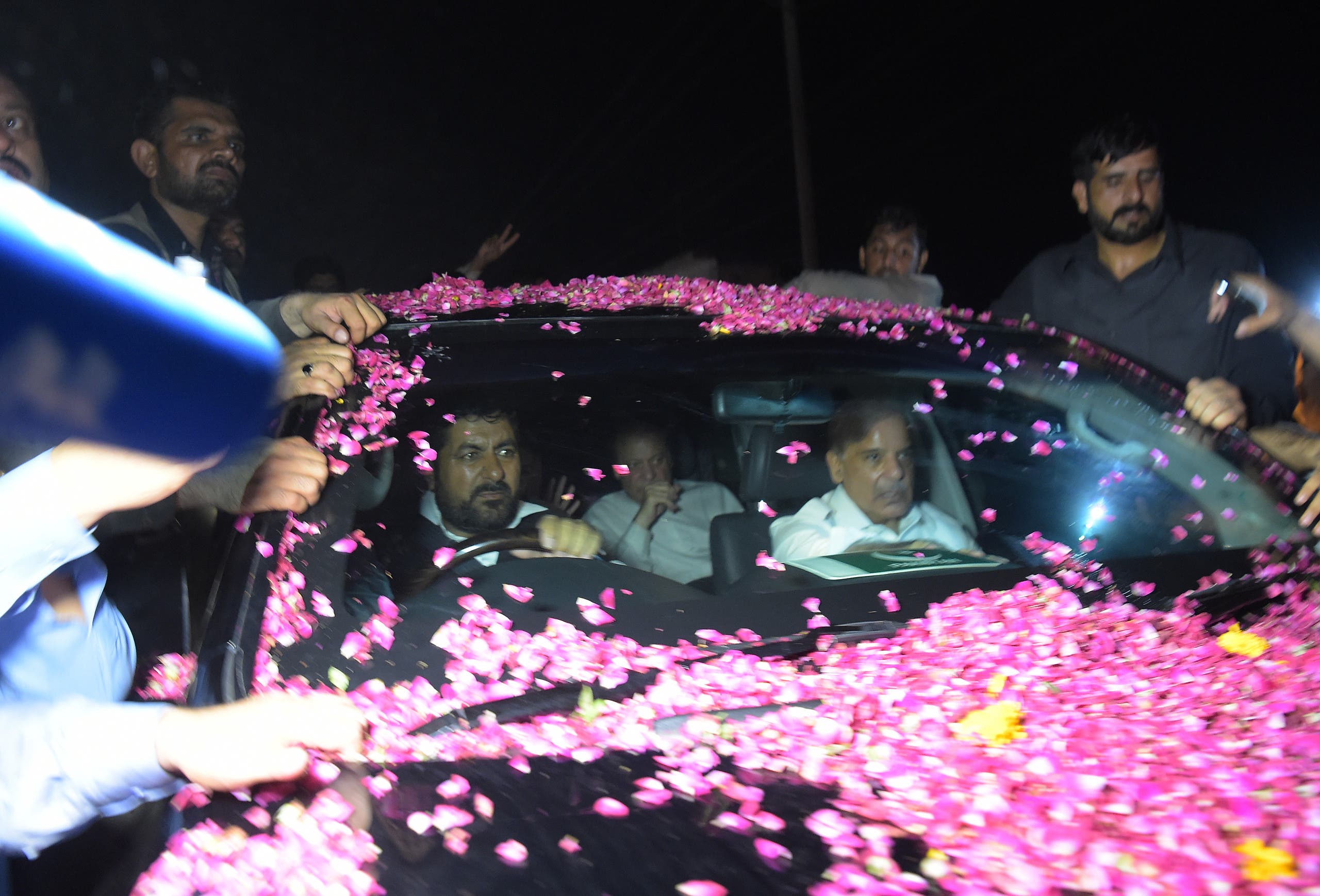 Former Pakistani Prime Minister Nawaz Sharif (C/ back) sits in a vehicle alongside his younger brother Shahbaz Sharif (R) following his release from Adiala prison in Rawalpindi on September 19, 2018.
