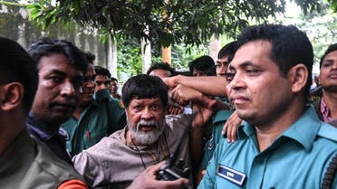 Activist and photographer Shahidul Alam arrives surrounded by policemen for an appearance in a court, in Dhaka on August 6, 2018. (AFP)
