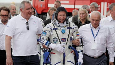 Roscosmos state space corporation head Dmitry Rogozin, (left), accompanies Russian cosmonaut Sergey Prokopyev (center), crew member of the mission to the International Space Station, ISS, to the rocket prior the launch. (AP) 
