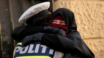 Denmark investigating viral photo of policewoman hugging niqab-wearing protester