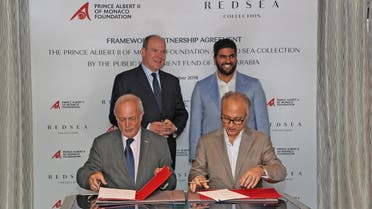 Prince Albert II of Monaco (left), Prince Badr bin Abdullah Al Saud, the Saudi Minister of Culture (right) attending the signing ceremony by Bernard Fautrier – Vice President and CEO of the Prince Albert II of Monaco Foundation, and Nicholas Naples (CEO Amaala - The Public Investment Fund).