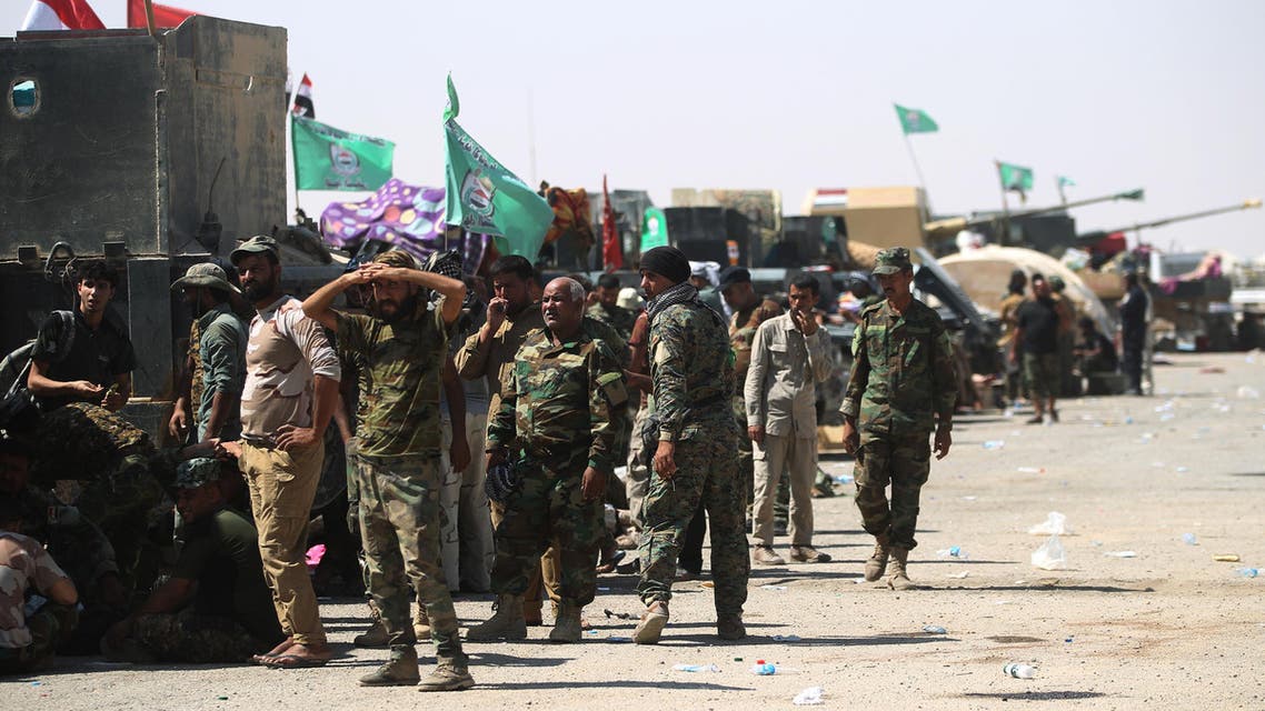 Fighters of Hashed Al-Shaabi (Popular Mobilization units) gather at the Tal Afar airport, west of Mosul, as Iraqi forces backed by local militia and a US-led coalition advanced in driving the Islamic State group from the city, on August 27, 2017. Just a week after authorities announced an offensive to push the jihadists from one of their last major urban strongholds in Iraq, the Joint Operations Command said Iraqi forces held all 29 districts of the city and were pursuing final mopping up operations.