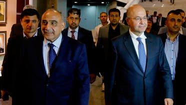 Iraq's new President Barham Salih, center right, walks with new Prime Minister Adel Abdul-Mahdi, center left, in the parliament building in Baghdad, Iraq, Tuesday, Oct. 2, 2018. (AP)