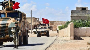 A handout picture realeased by the Turkish Armed Forces shows Turkish soldiers accompanied by armoured vehicles patrolling between the city of Manbij in northern Syria and an area it controls after a 2016-2017 military incursion on June 18, 2018. Turkey said it had started military patrols in an area around the Kurdish-held city of Manbij, in line with an agreement with the United States to scale down tensions in the region.