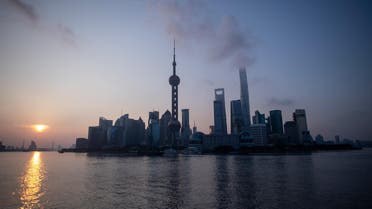 The sun rises behind the skyline of Shanghai in the Lujiazui Financial District of Pudong on August 8, 2018. (AFP)