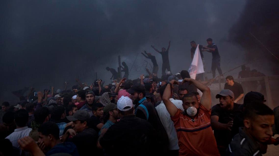 Palestinians chant angry slogans as they cut the fence during a protest at the Gaza Strip’s border with Israel, Friday, Oct. 5, 2018. (AP)