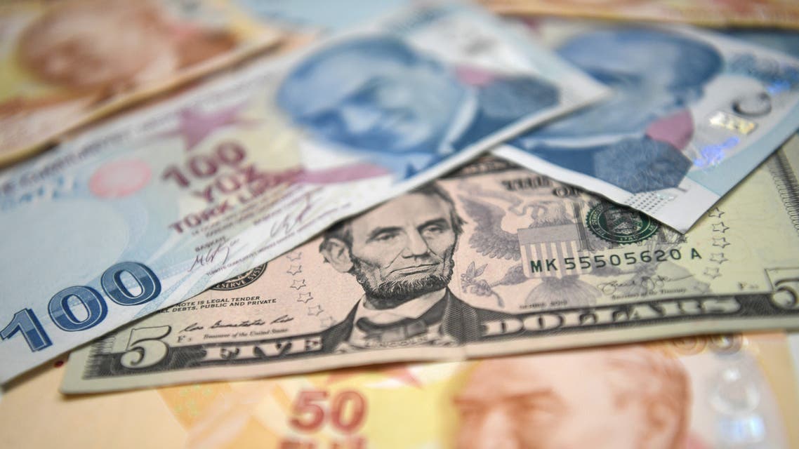 A picture taken in Istanbul on May 23, 2018 shows Turkish lira and US dollars banknotes. Turkey's embattled lira on May 23, 2018 hit new historic lows against the US dollar after suffering a hammering in Asian trade, as markets watched to see if the central bank takes emergency action to buttress the currency.