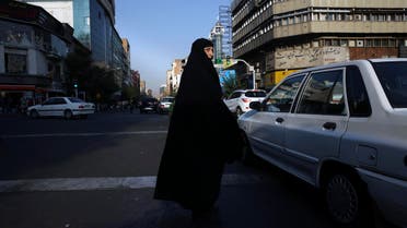 A veiled Iranian woman crosses Jomhouri-e-Eslami (Islamic Republic) St. in downtown Tehran on July 30, 2018. (AP)