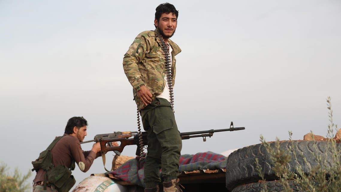 A Syrian rebel-fighter from the National Liberation Front (NLF) gather on the frontline with regime forces inside the demilitarised zone, in the south east of Idlib province on October 9, 2018. Jihadist factions including Syria's former Al-Qaeda branch have withdrawn heavy weapons from parts of a planned buffer zone in Idlib province, a monitor said on October 9, two days ahead of a deadline. The U-shaped buffer, agreed by regime ally Russia and rebel-backer Turkey, will separate opposition and government forces and is meant to be free of both heavy weapons and jihadists by October 15.