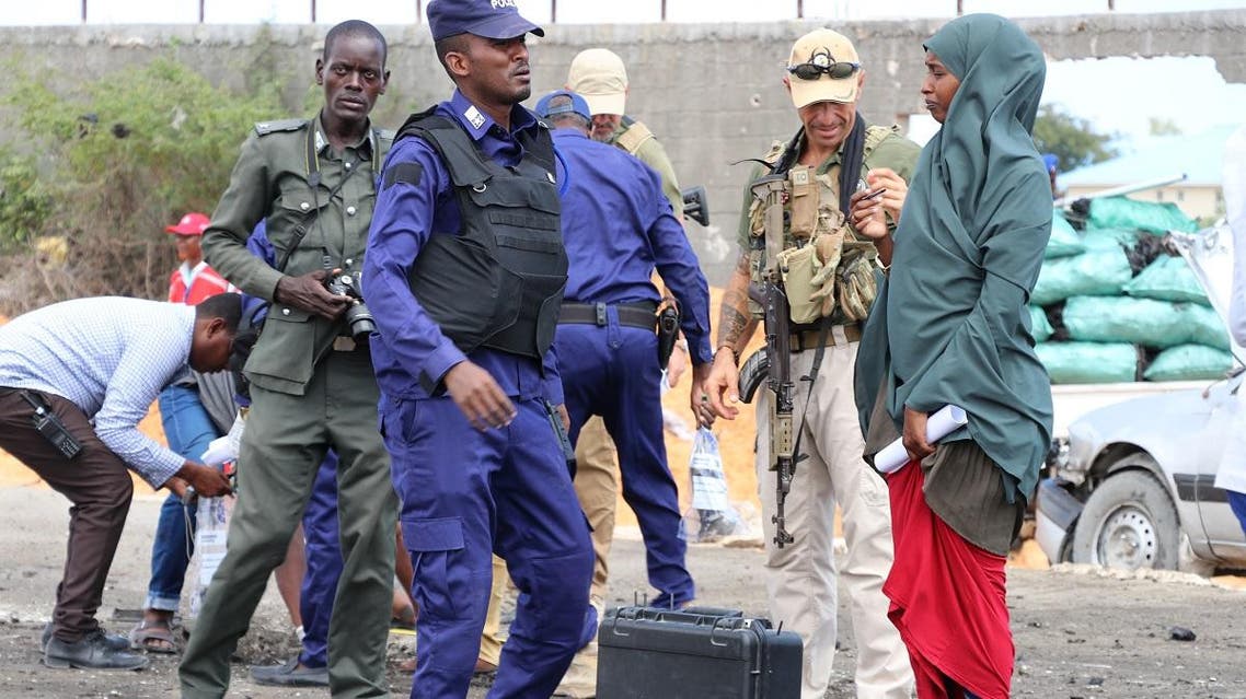 Somalia police and other security officers investigate the scene of a suicide bomb attack in the capital, Mogadishu on October 1, 2018. (AFP)