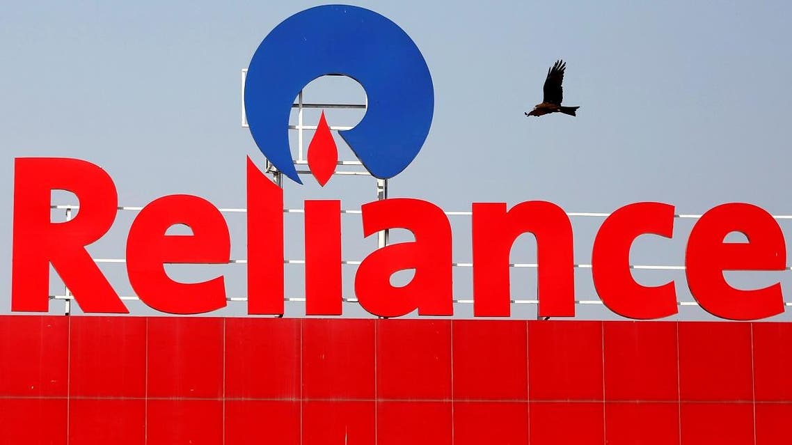 A bird flies past a Reliance Industries logo installed on its mart in Ahmedabad, India January 16, 2017. REUTERS