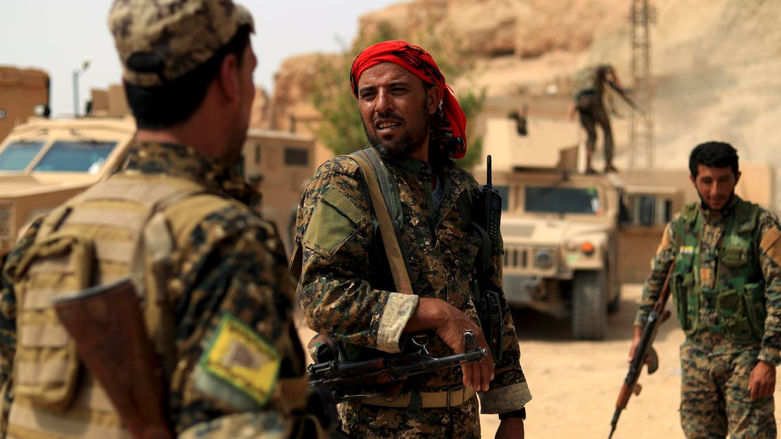 Members of the Syrian Democratic Forces (SDF) gather in the village of Susah in the eastern province of Deir Ezzor, near the Syrian border with Iraq on September 13, 2018. US-backed fighters are fighting in Deir Ezzor to oust Islamic State jihadists from the town of Hajin on the east bank of the Euphrates, the most significant remnant of the sprawling "caliphate" the jihadists once controlled spanning Syria and Iraq.