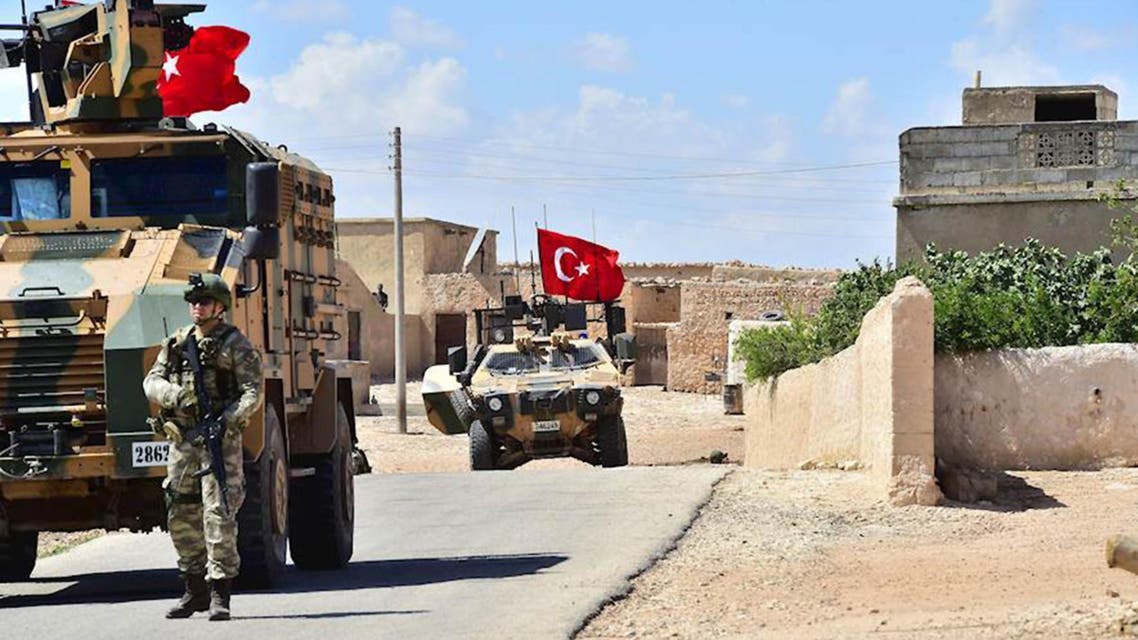 A handout picture realeased by the Turkish Armed Forces shows Turkish soldiers accompanied by armoured vehicles patrolling between the city of Manbij in northern Syria and an area it controls after a 2016-2017 military incursion on June 18, 2018. Turkey said it had started military patrols in an area around the Kurdish-held city of Manbij, in line with an agreement with the United States to scale down tensions in the region.