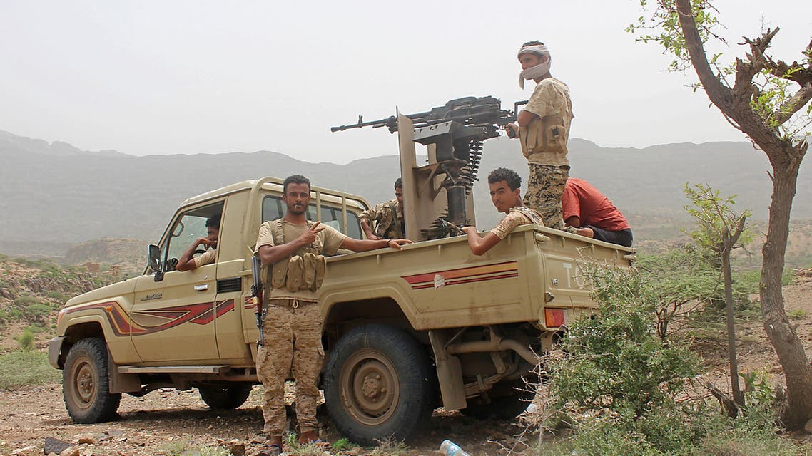Yemeni pro-government fighters sit at the back of an armed pick-up as Emirati supported forces take over Huthi bases on the frontline of Kirsh between the province of Taez and Lahj, southwestern Yemen, on July 1, 2018. The United Arab Emirates on Sunday announced it had halted the offensive it is backing against Huthi rebels in Yemen's port city of Hodeida to give a chance to UN diplomatic efforts.