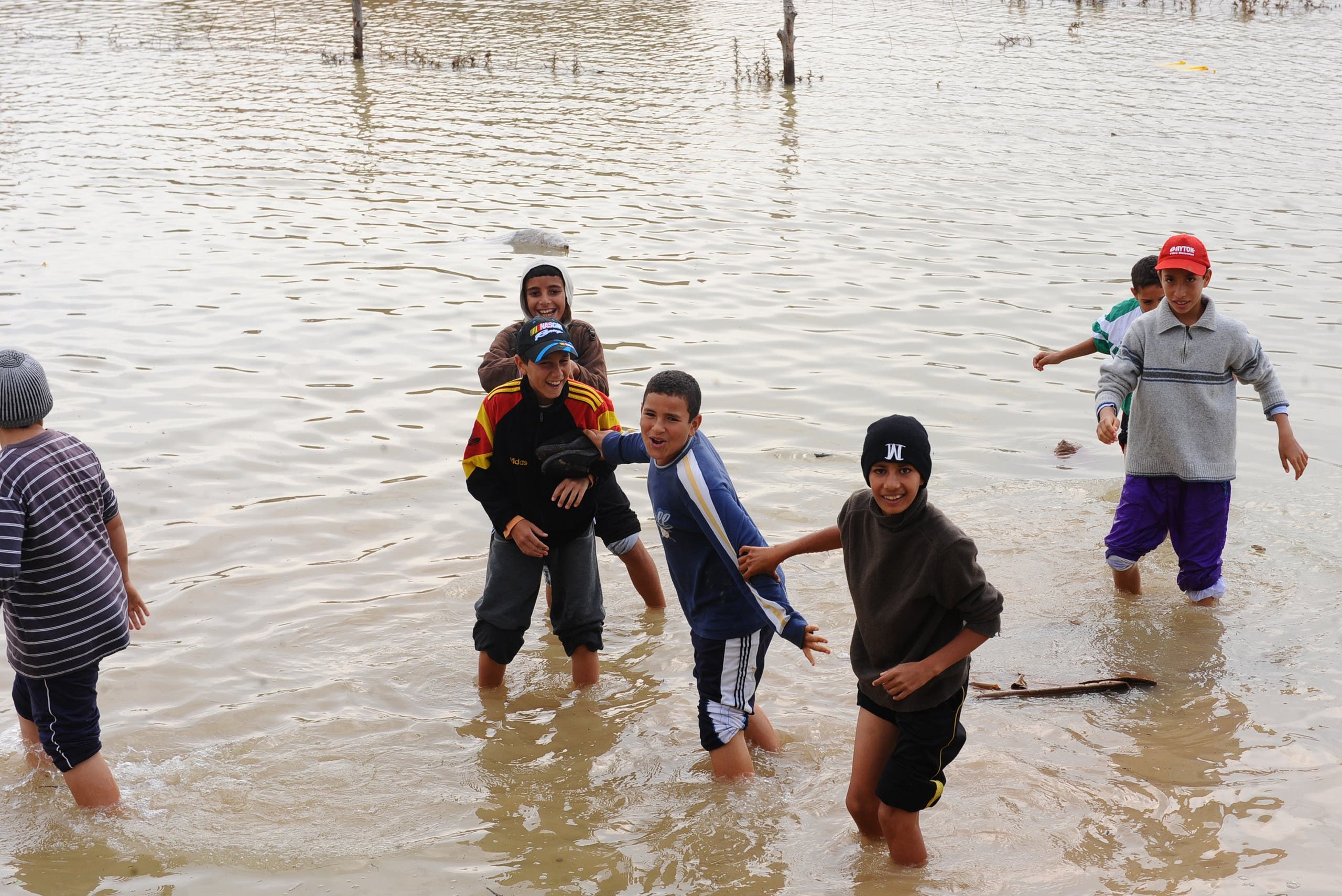 Kids play in floodwater in the northern Tunisia village of Houcine invaded with floodwater on November 2, 2011 near Majaz al Bab in Beja’s province. (AFP)
