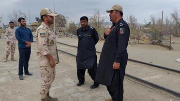 In this photo taken on October 16, 2018, a Pakistani border security official (R) and an Iranian border official meet at Zero Point in the Pakistan-Iran border town of Taftan. At least 11 Iranian security personnel, including Revolutionary Guards intelligence officers, were abducted on the southeastern border with Pakistan on October 16, state media reported. State news agency IRNA said 14 troops were seized, while local media and other sources gave the number as 11.